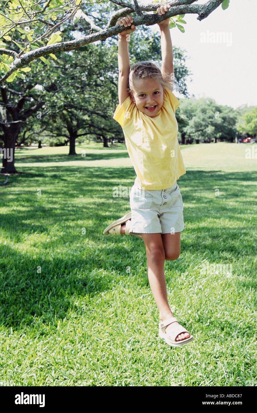 Girl swinging from tree Stock Photo Alamy