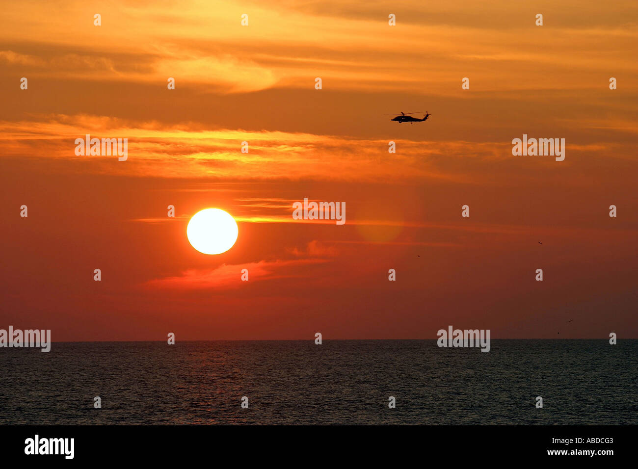 Sunset with helicopter Stock Photo