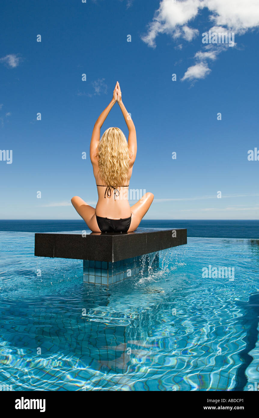 Woman practicing yoga on a platform Stock Photo
