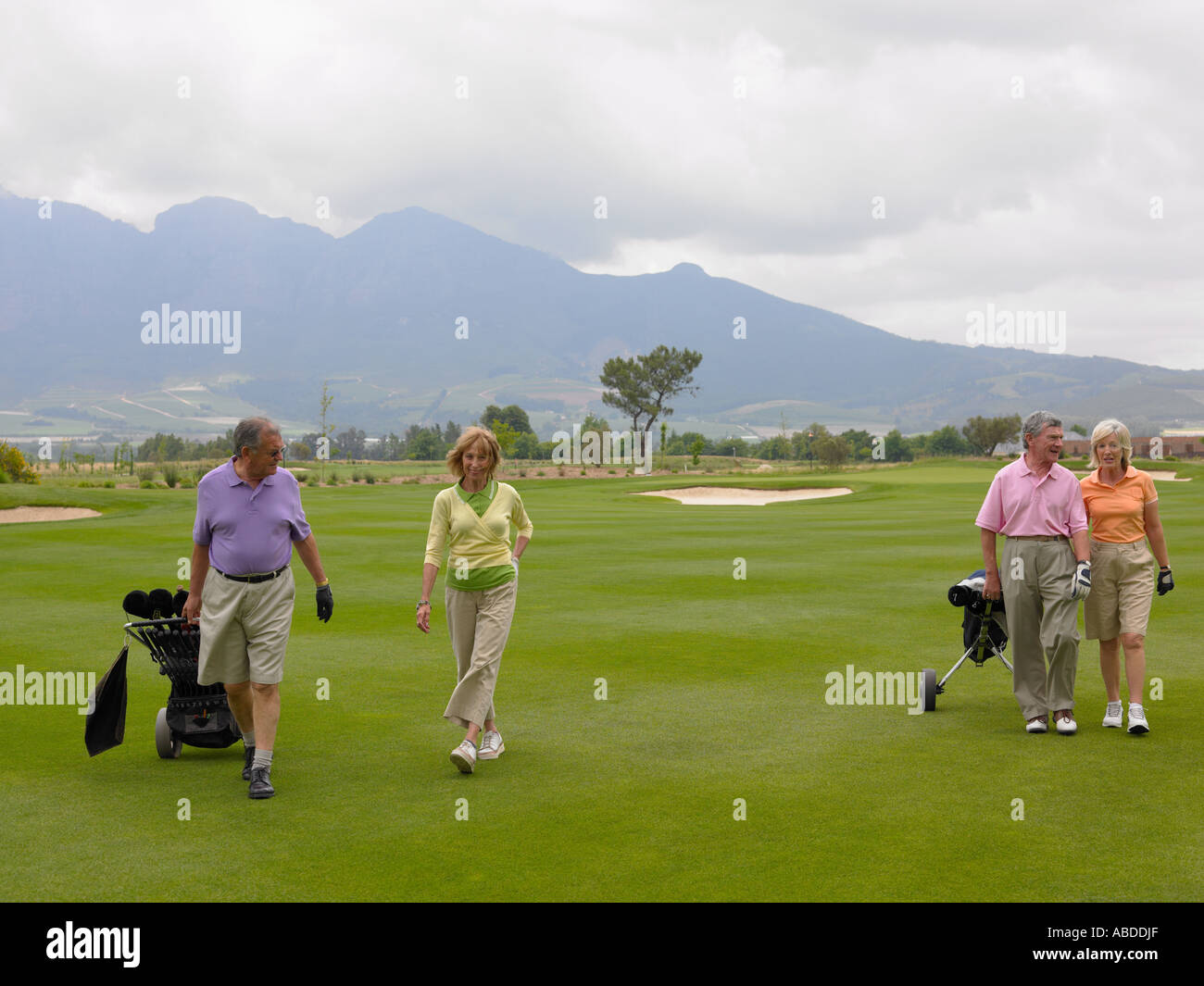 Senior couples on golf course Stock Photo - Alamy