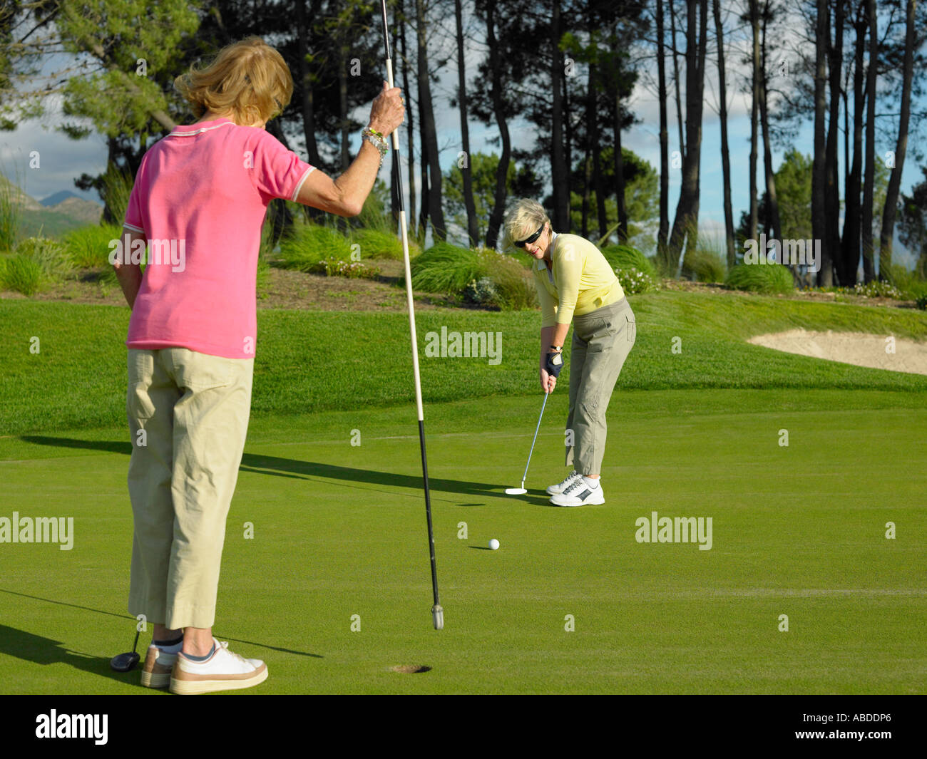 Women playing golf Stock Photo - Alamy