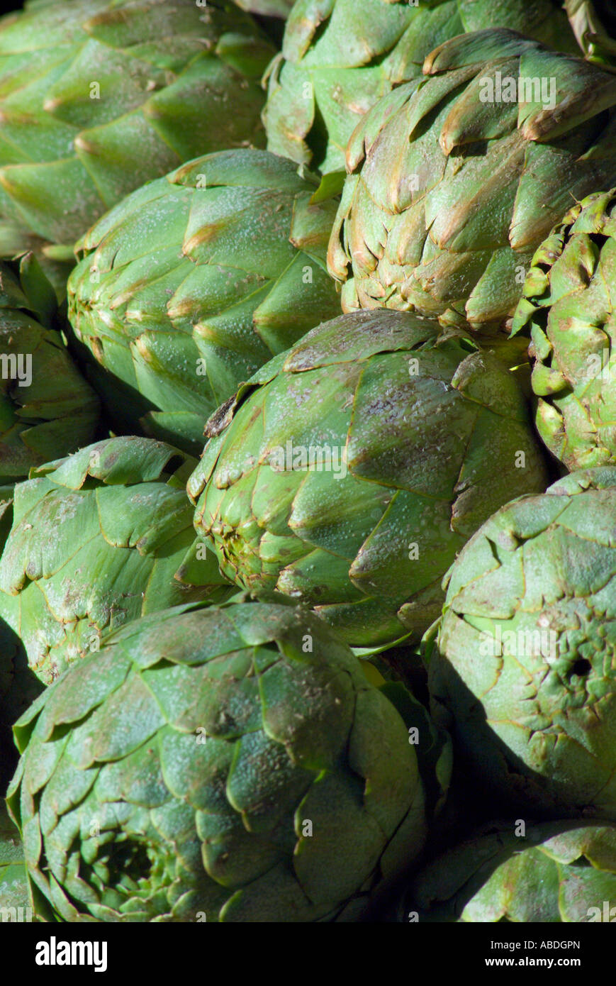 Stacks of artichokes in open air market Stock Photo