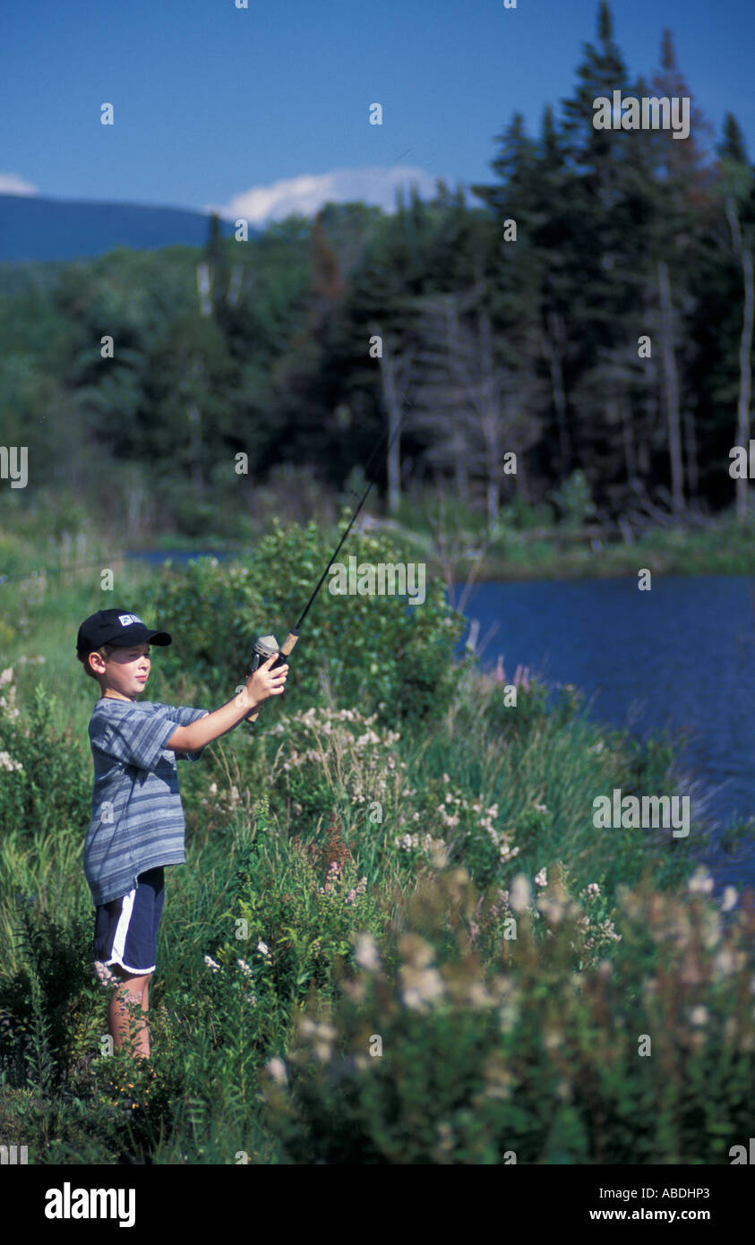 Randolph NH A young boy tries his luck at fishing on a beaver pond in