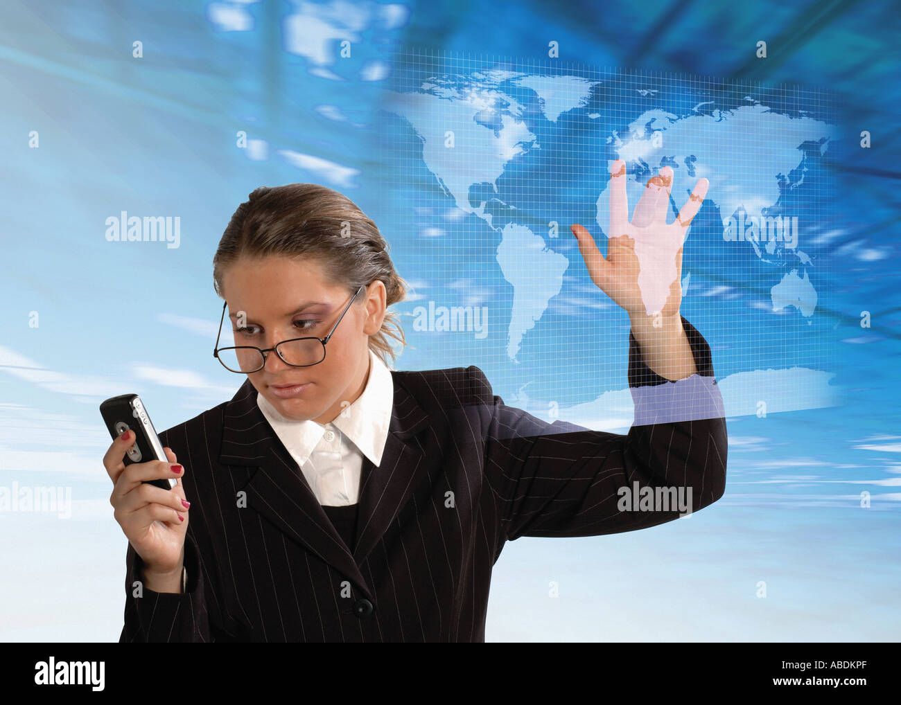 Woman with a cell phone picking on a world map in a virtual world Stock Photo