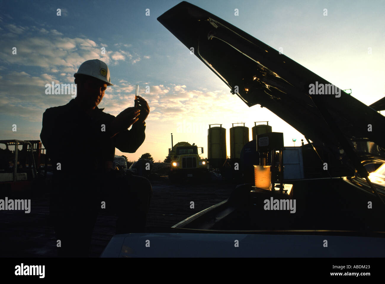 An engineer for an oil company does testing while at an oil rig Stock Photo