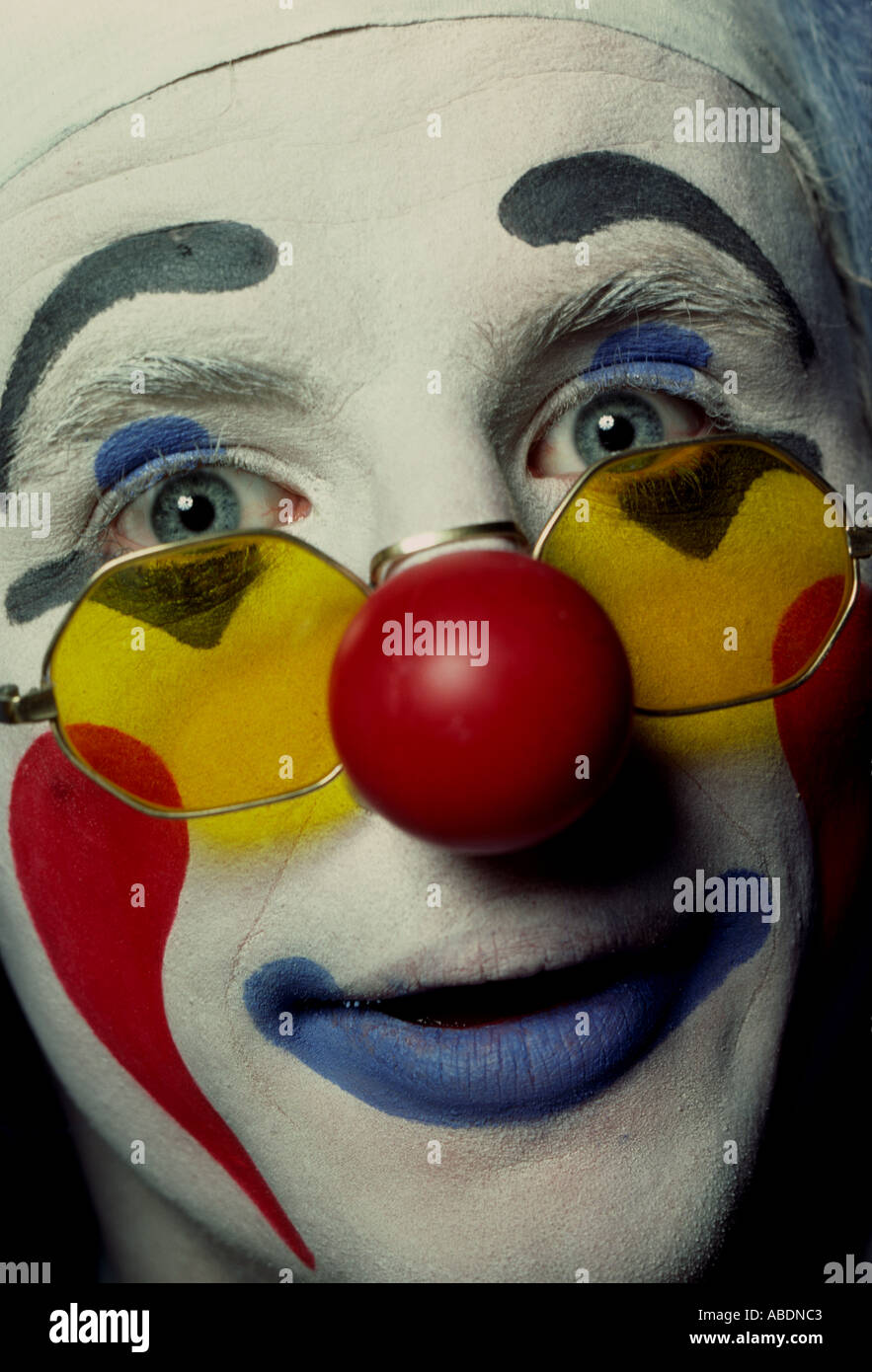 A white face circus clown poses for the camera between performances Stock Photo