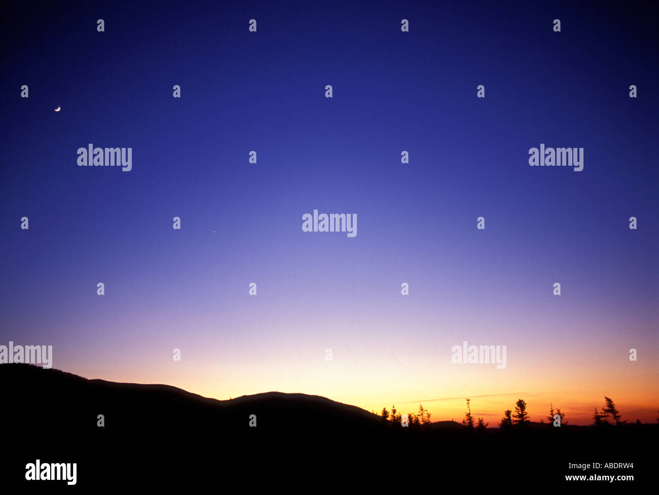 A crescent moon in a fading sky over NH s Pemigewasset Wilderness Sunset The Twinway Appalachian Trail Stock Photo