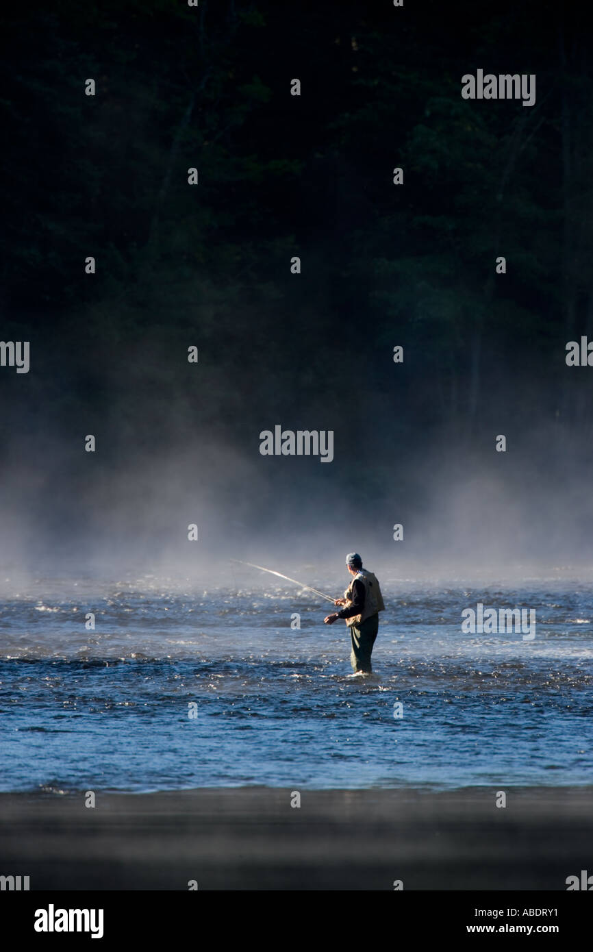 Fly fishing in the early morning mist on the Androscoggin River just