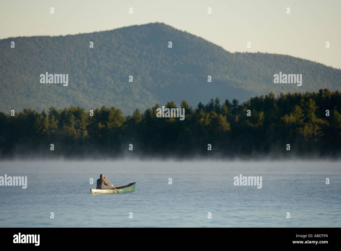 A paddler canoeing on Umbagog Lake near the Umbagog Lake State
