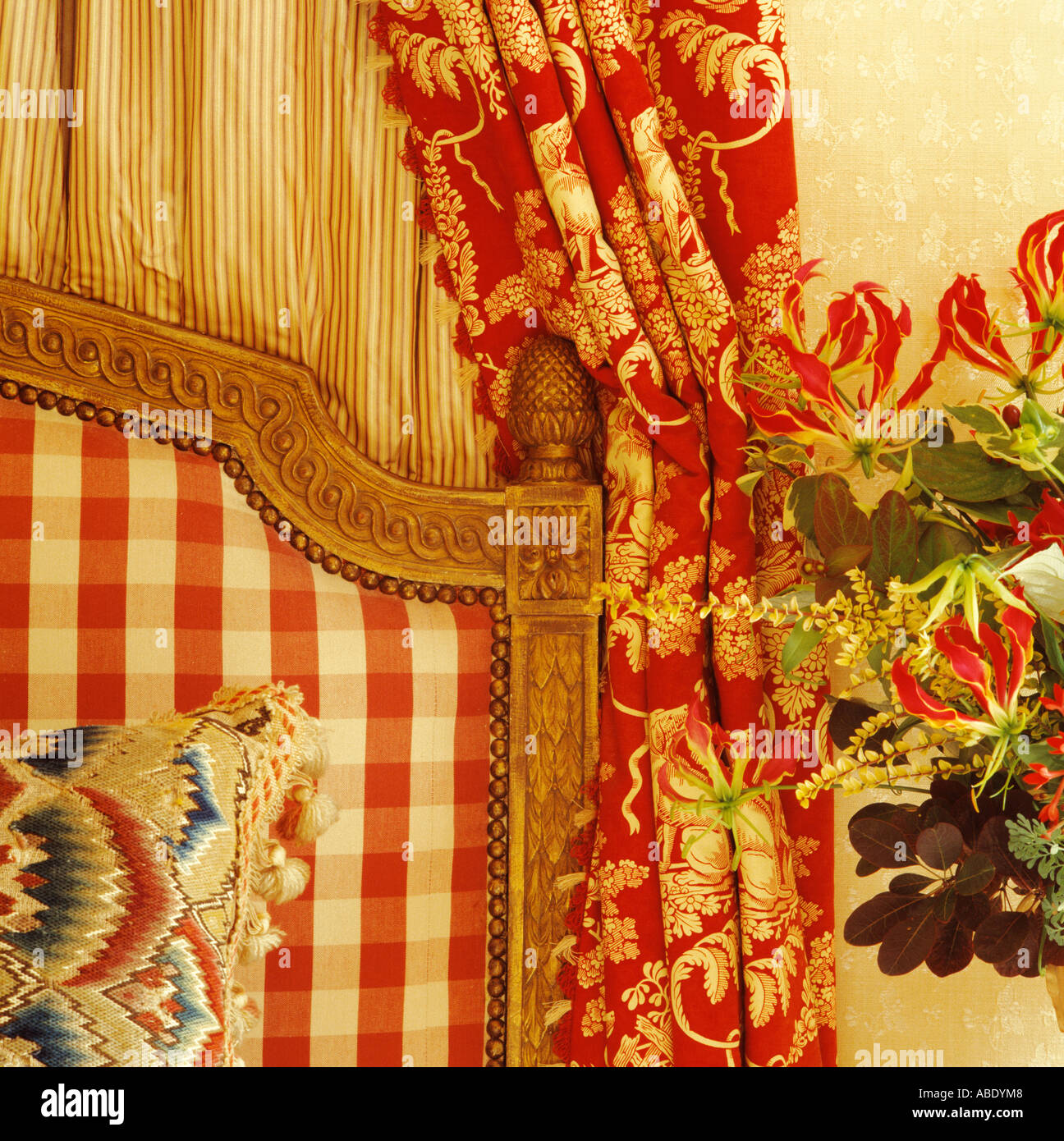 Close Up Of Red White Checked Upholstered Headboard And Red Floral