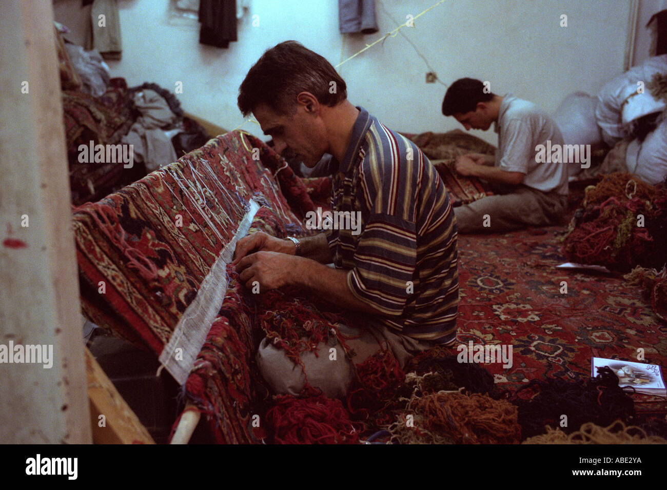 Mending carpets, Grand Bazaar, Tehran Iran ©2005 Mark Shenley Stock ...