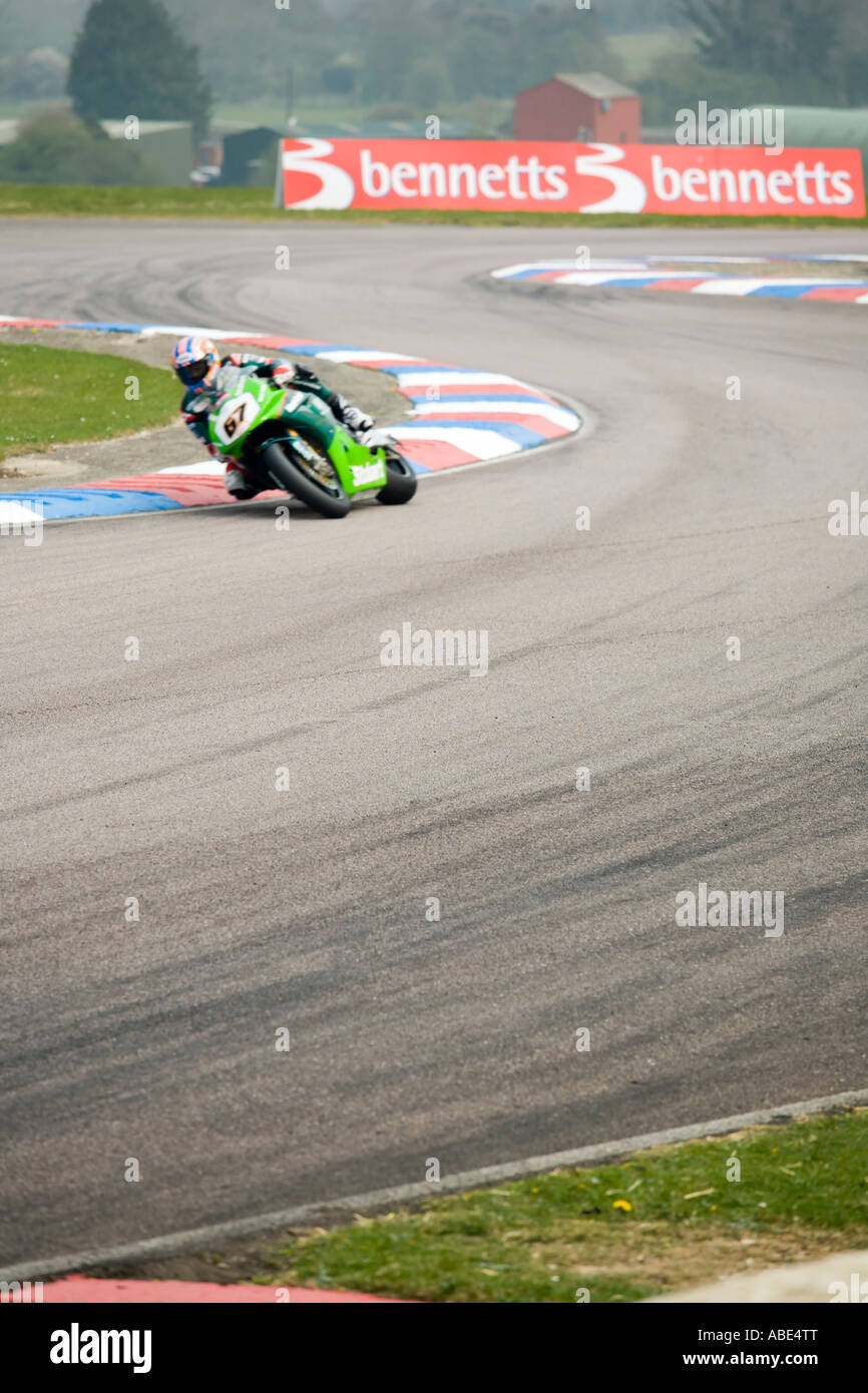 Action shot of Green racing motorbike leans into a corner Stock Photo