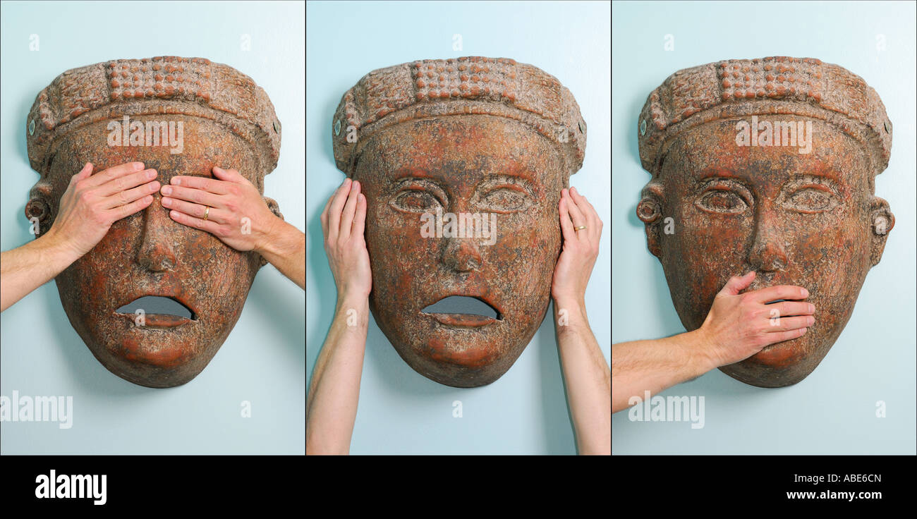 See no evil hear no evil and speak no evil triptich of arms on a mask Stock Photo