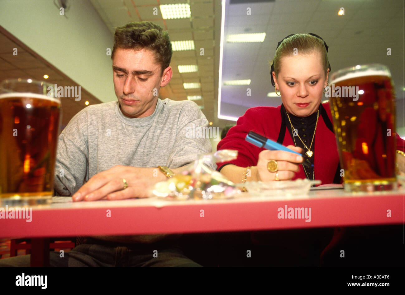 A man and a woman playing bingo in a South London Bingo Hall. Stock Photo