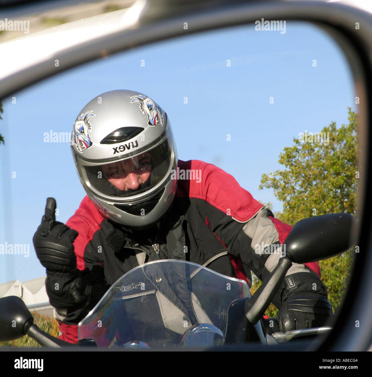 Annoyed biker shows the middle finger Stock Photo Alamy