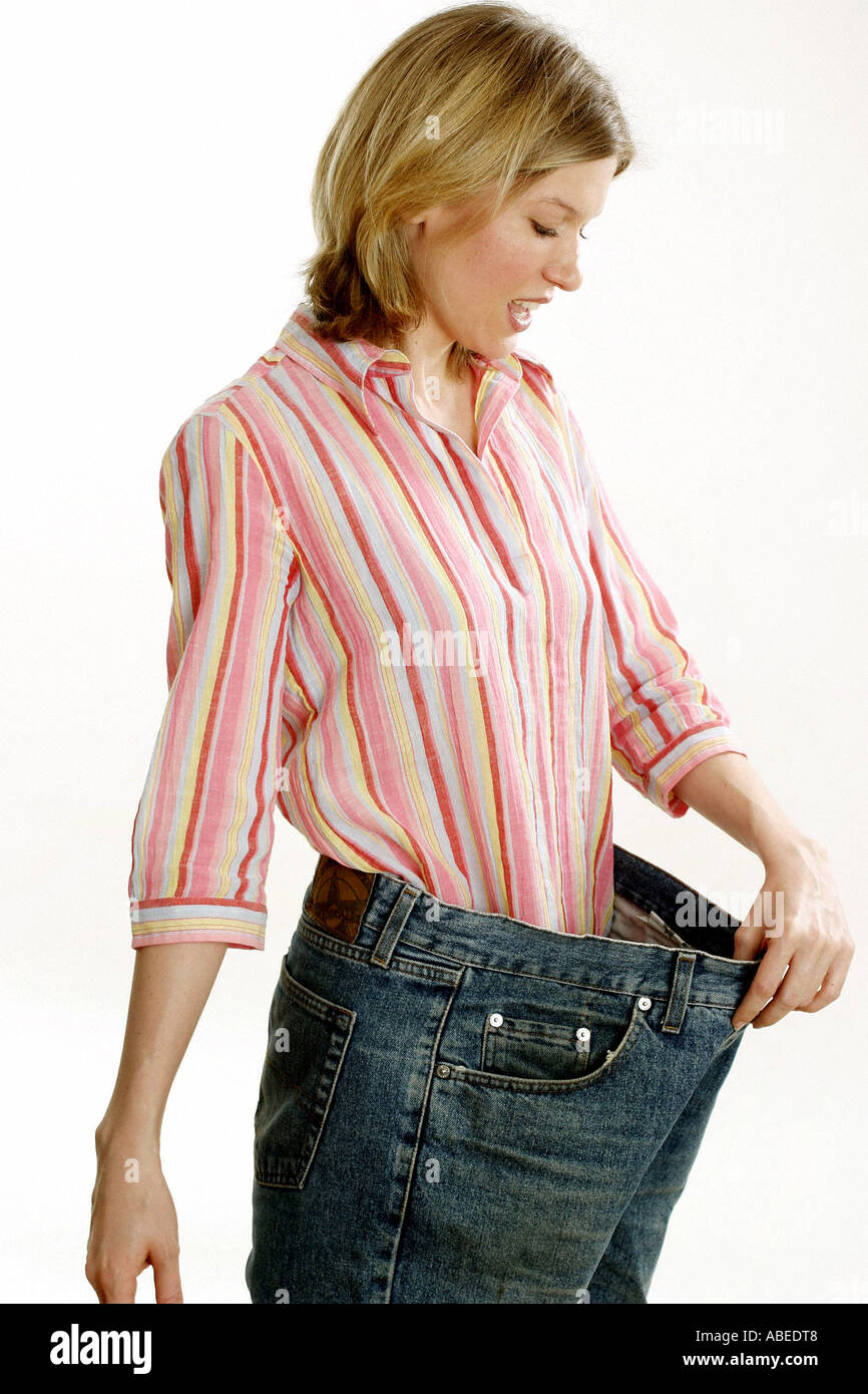 Woman after weight loss with large trousers Stock Photo - Alamy