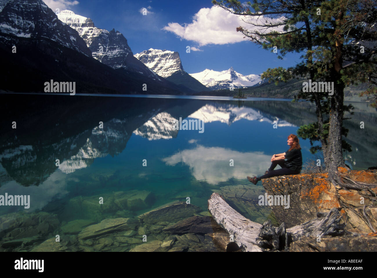 Person overlooking St Mary Lake at Waterton Glacier International Peace Park / Montana Stock Photo