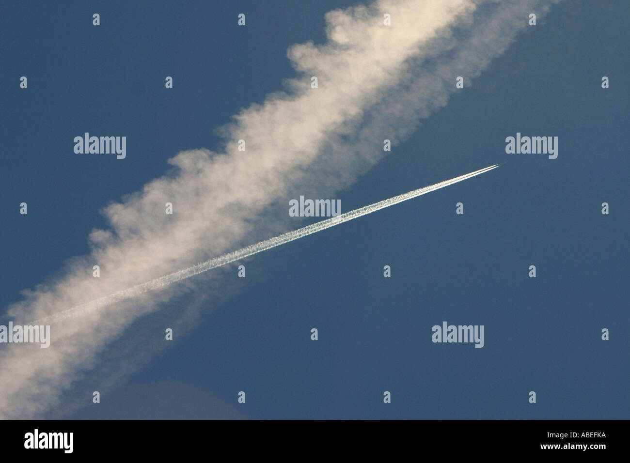 airplane with vapour trail Stock Photo