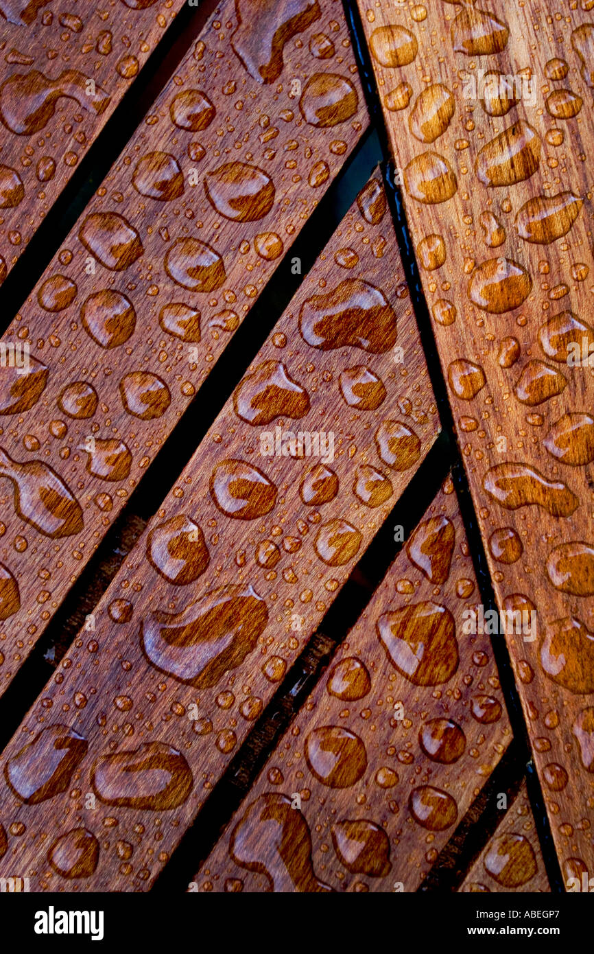 Rain droplets on a wooden garden table Stock Photo