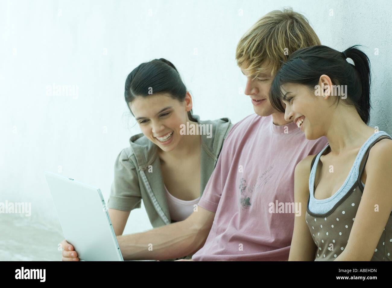 Group of young friends using laptop together Stock Photo