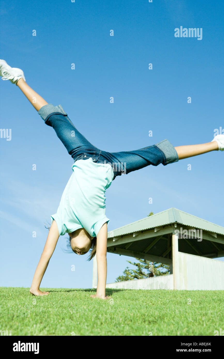 Girl doing cartwheel on grass Stock Photo Alamy