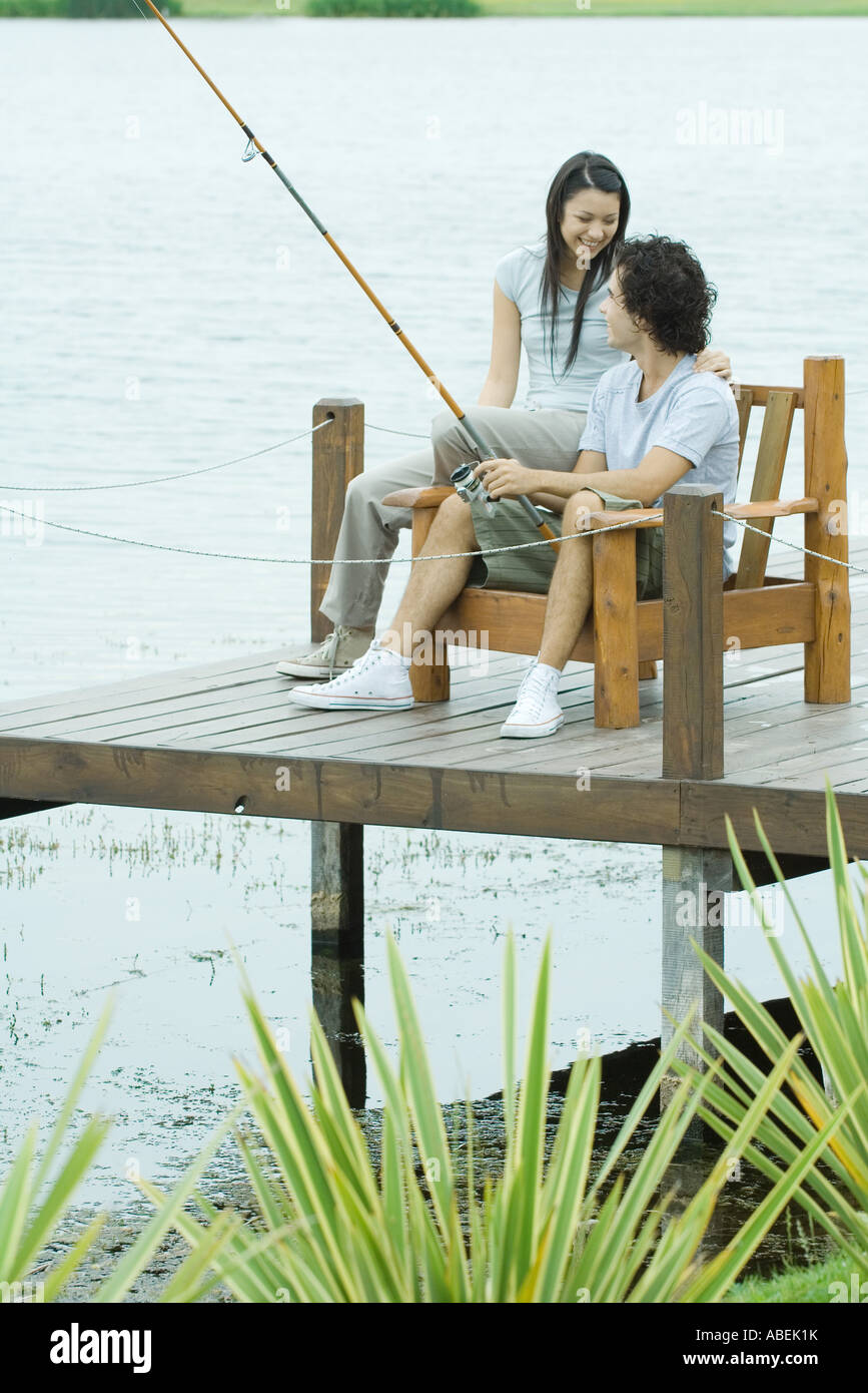 Couple fishing on pier Stock Photo