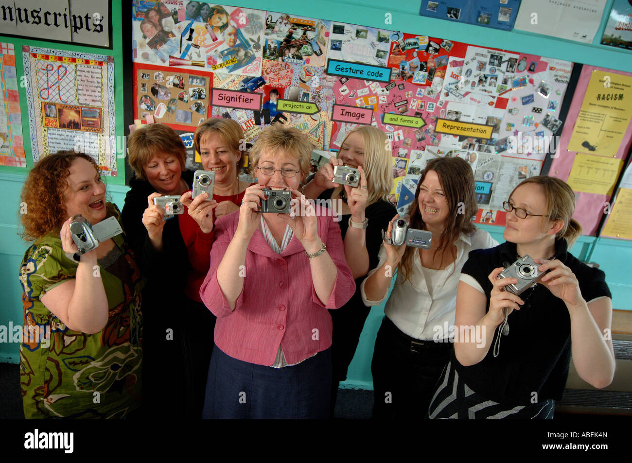 A group of teachers at a school using digital cameras in a classroom