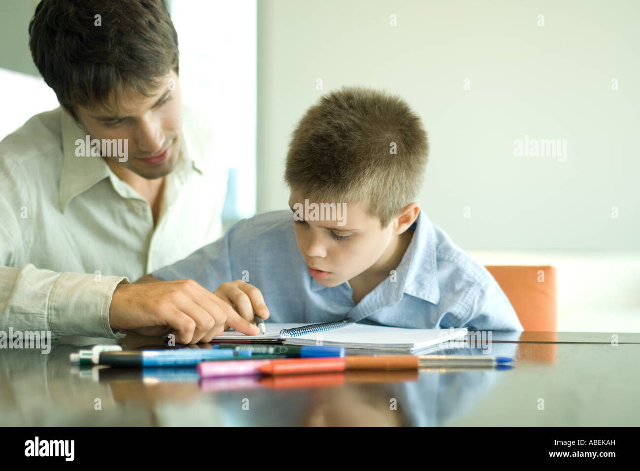 Father and son doing homework together Stock Photo - Alamy