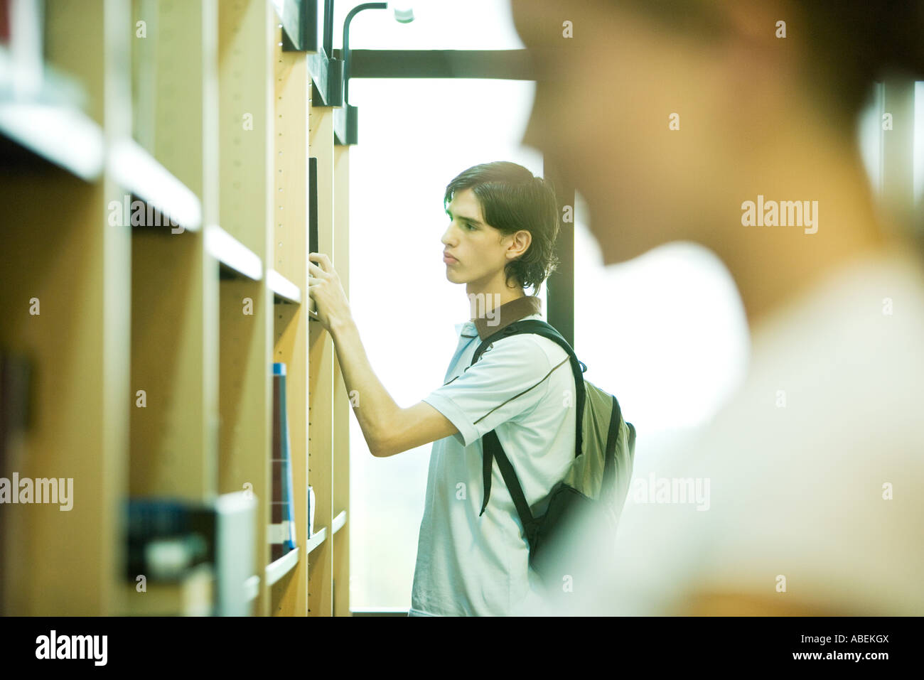 Students looking at shelves in college library Stock Photo Alamy
