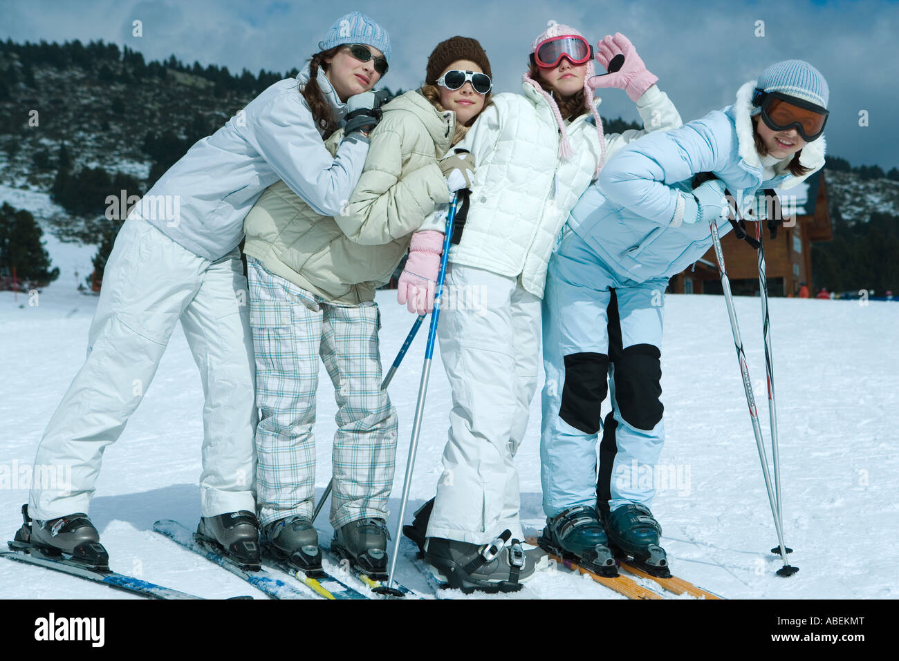 Young skiers standing on ski slope, full length portrait Stock Photo