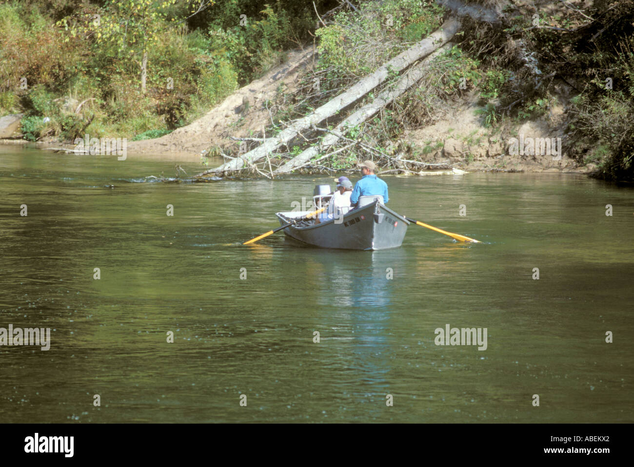 Fishing from a boat in a river Stock Photo