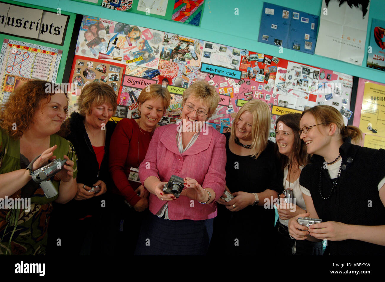 A group of teachers at a school using digital cameras in a classroom