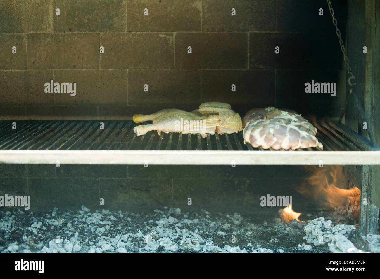 Meats grilling in wood oven Stock Photo Alamy