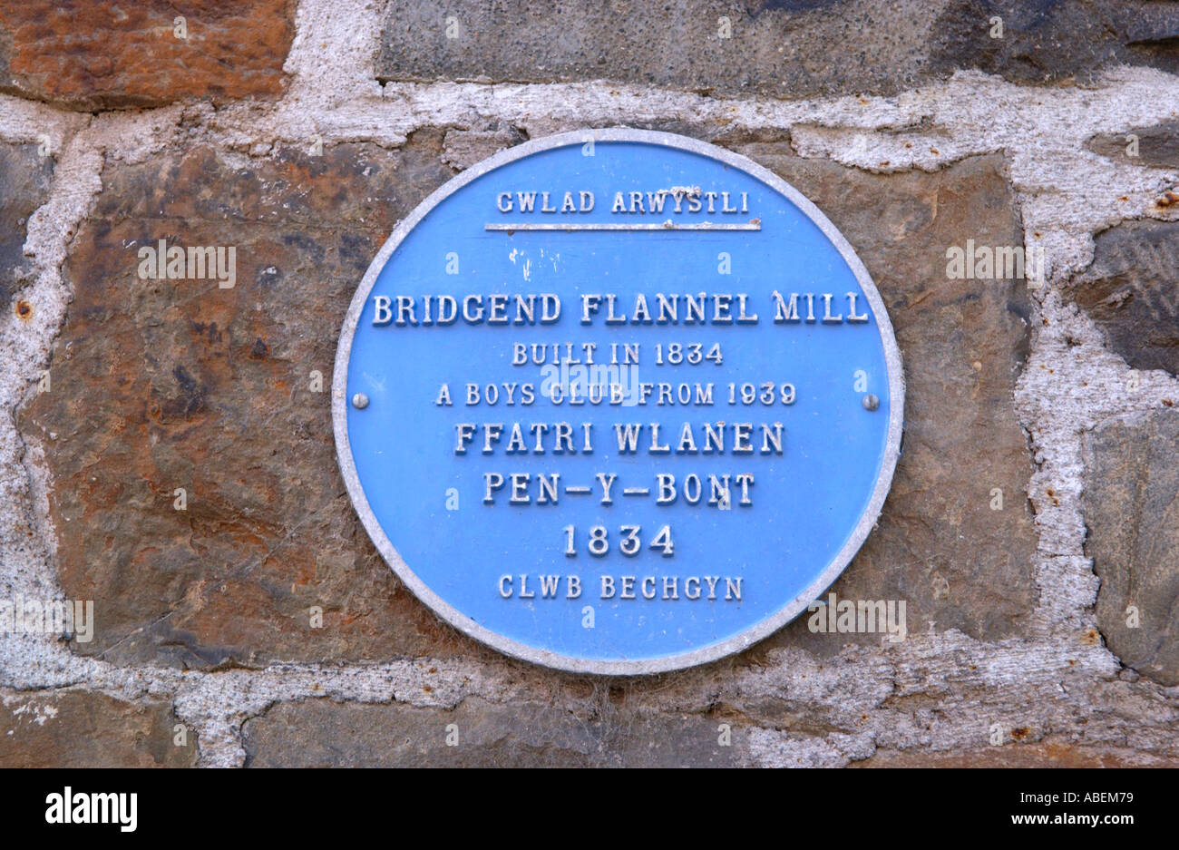 Blue plaque on former flannel mill converted to apartments on the banks of the River Severn at Llanidloes Powys Mid Wales UK Stock Photo