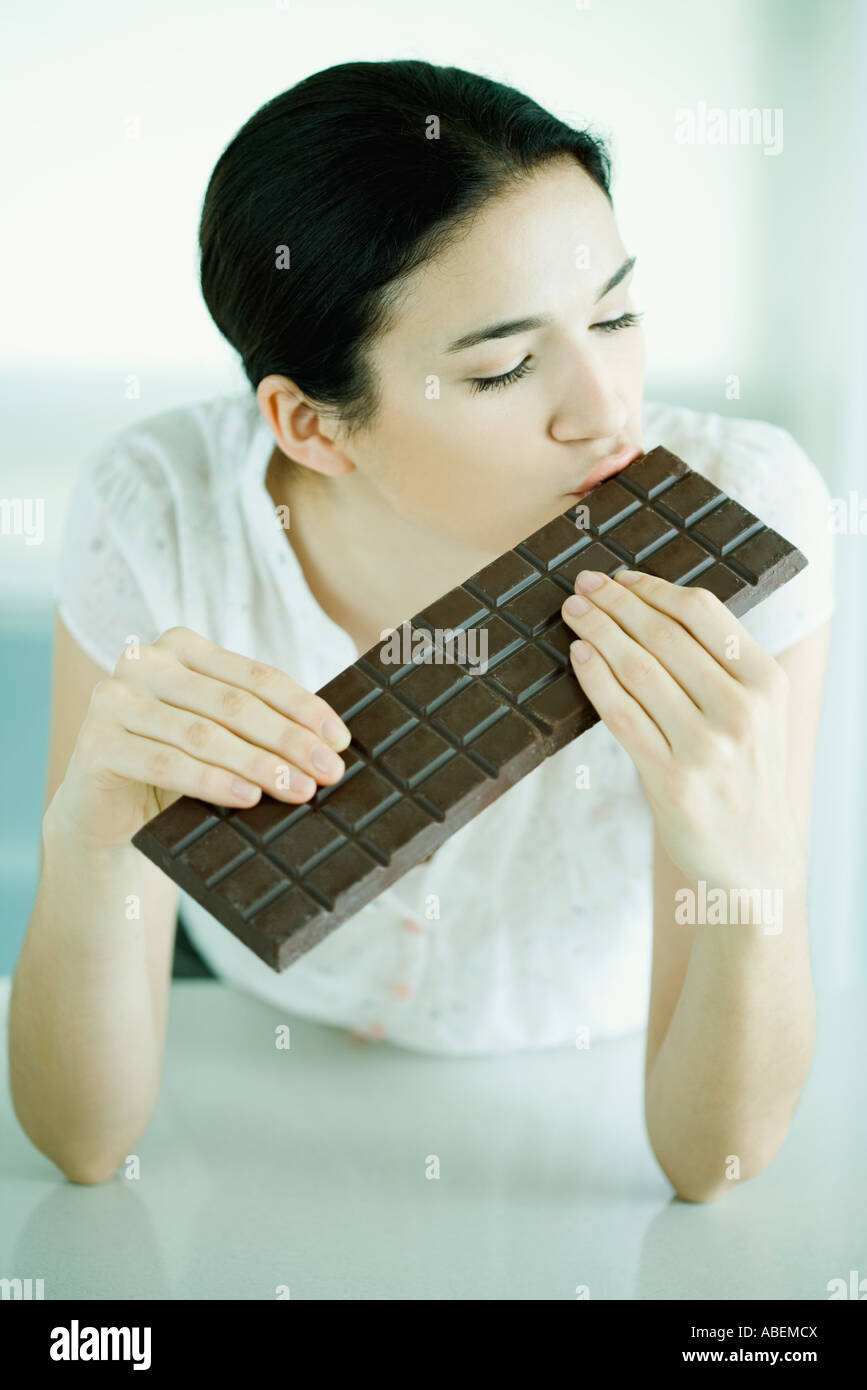 Woman kissing large bar of chocolate Stock Photo Alamy