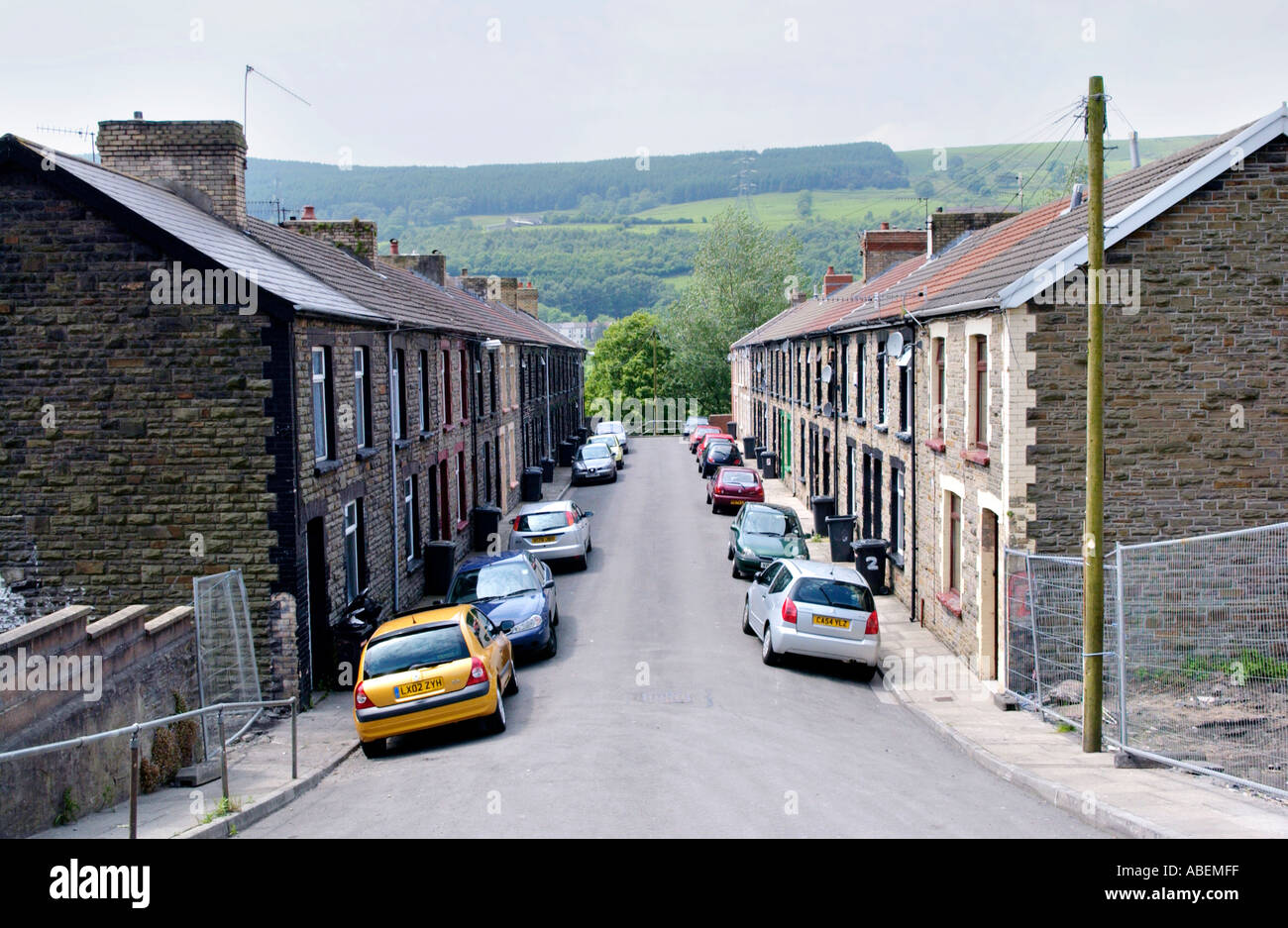 Terraced houses with cars parked outside at Merthyr Vale a former coal mining village near Merthyr Tydfil South Wales Valleys UK Stock Photo