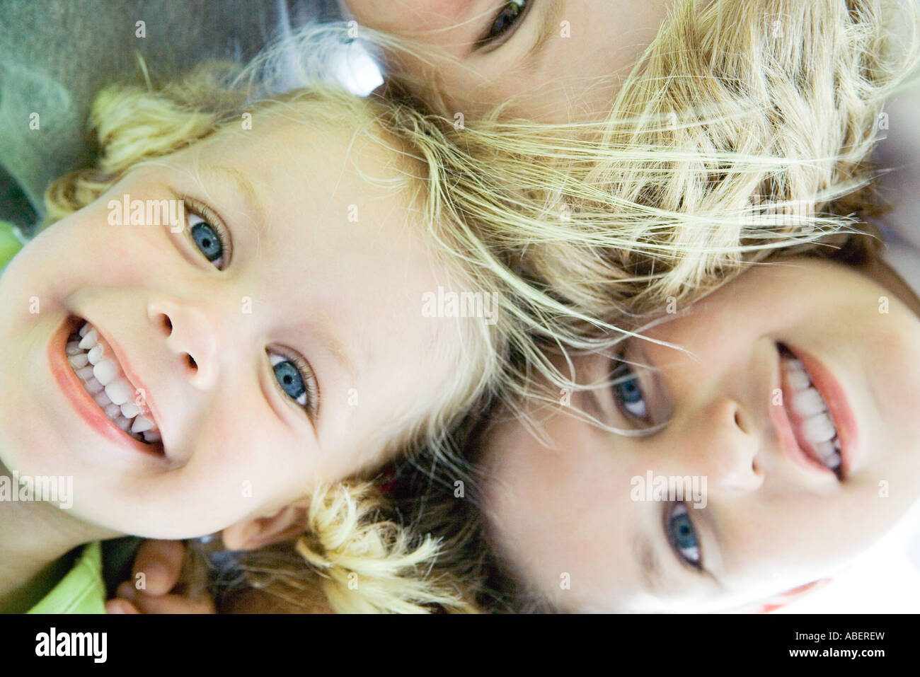 Children with heads together, low angle view Stock Photo