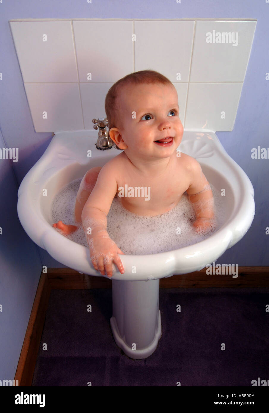 Baby Having A Wash In A Bathroom Sink Stock Photo 12871886