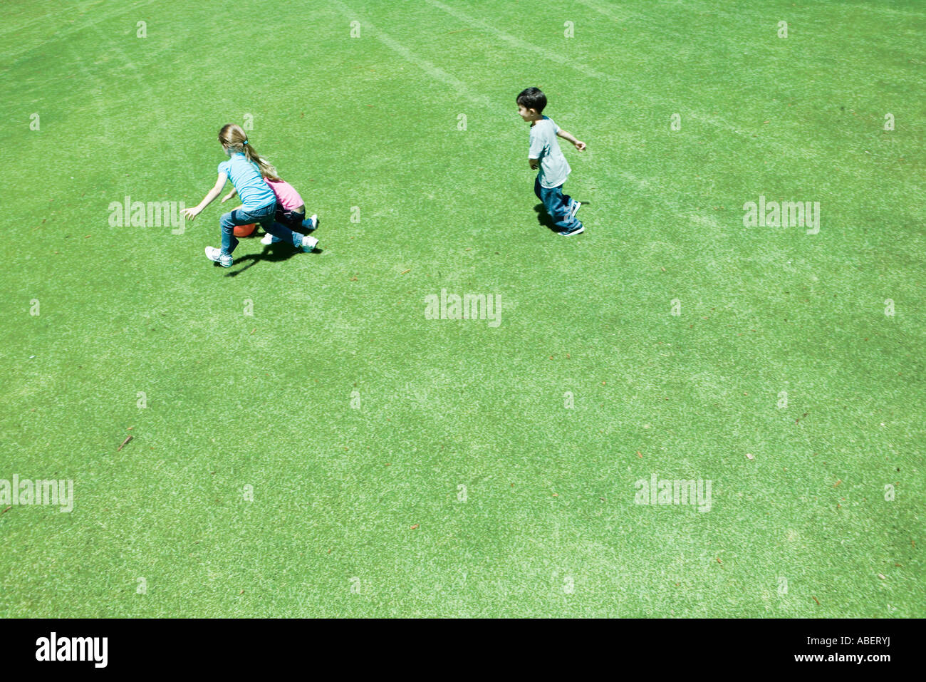 Children playing ball on grass Stock Photo Alamy