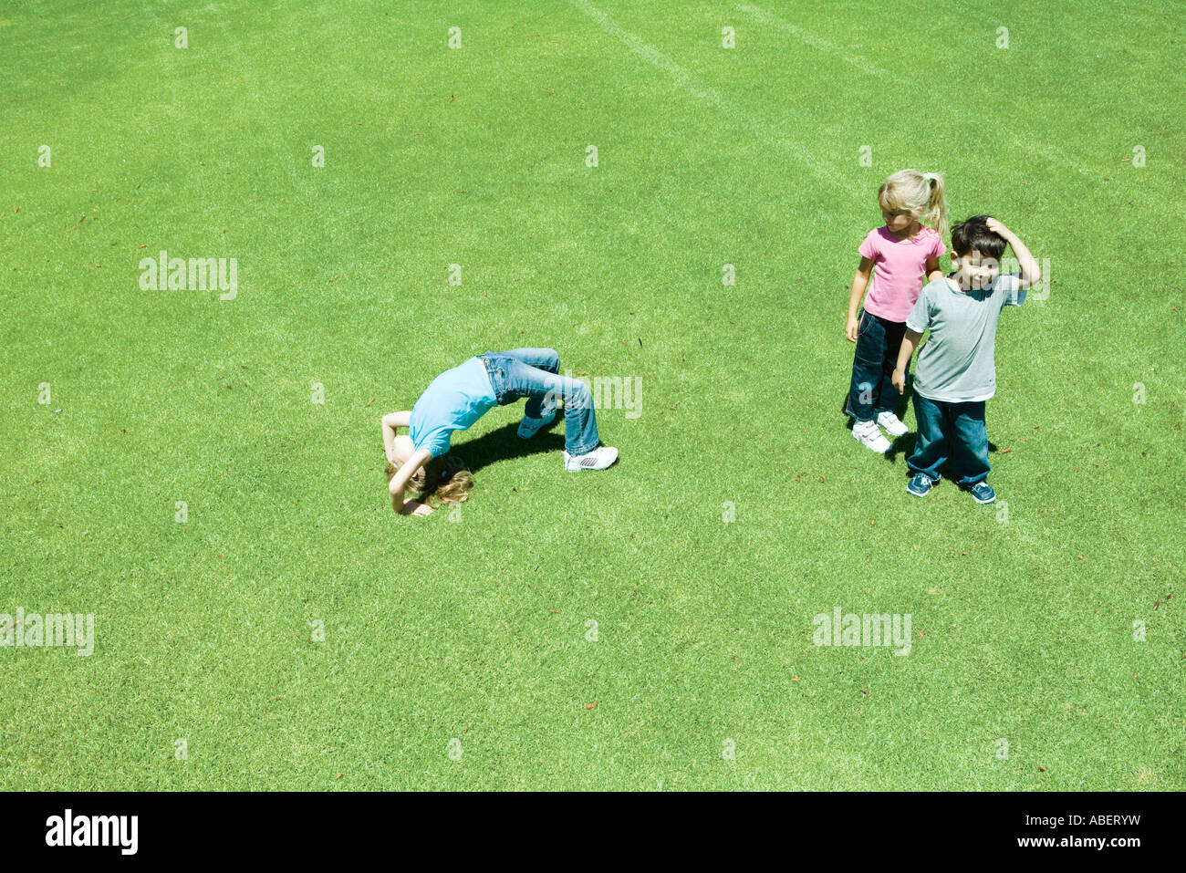 Children playing ball on grass Stock Photo