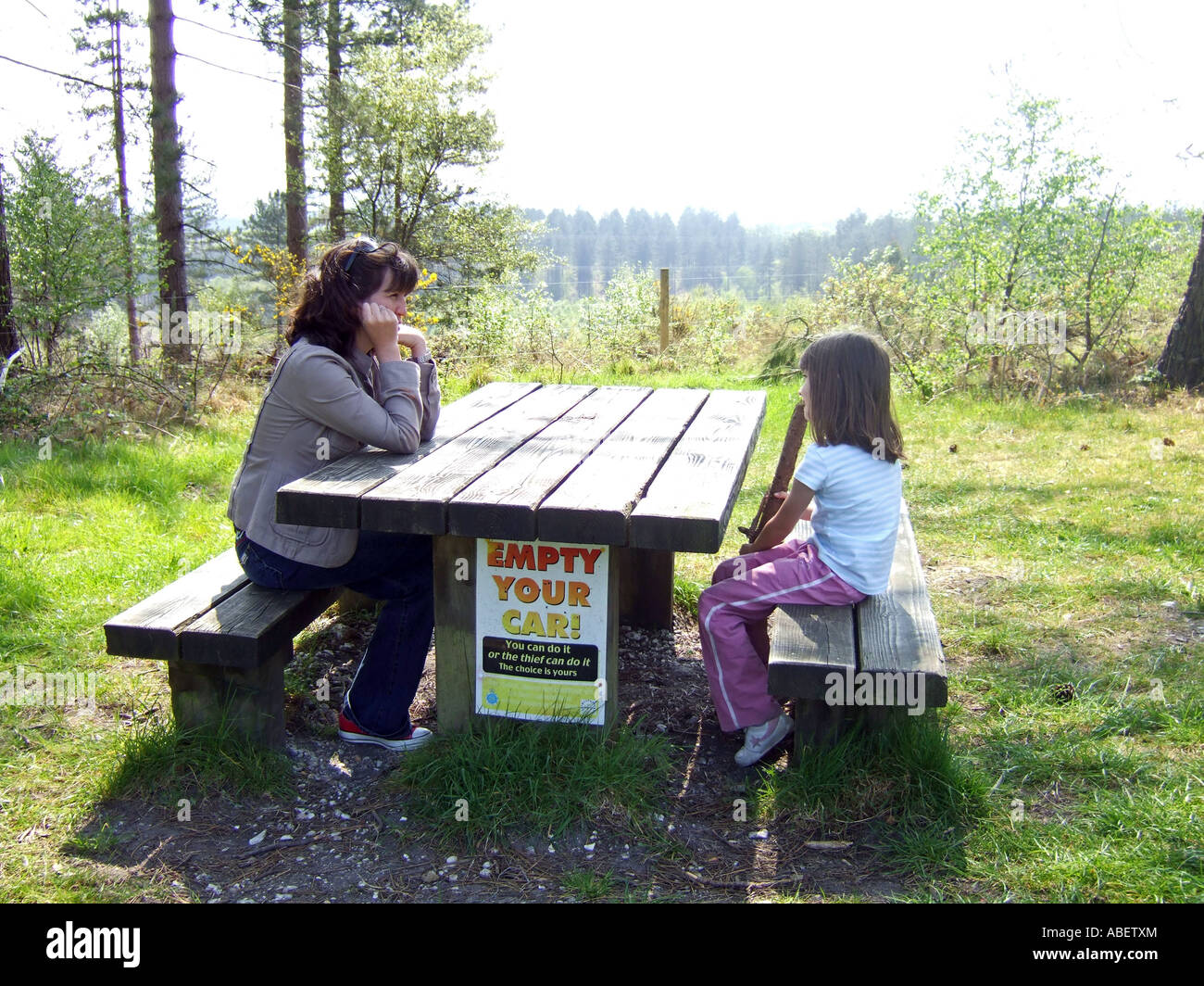 Empty your car warning sign on a picnic bench, Dorset Britain, UK Stock Photo