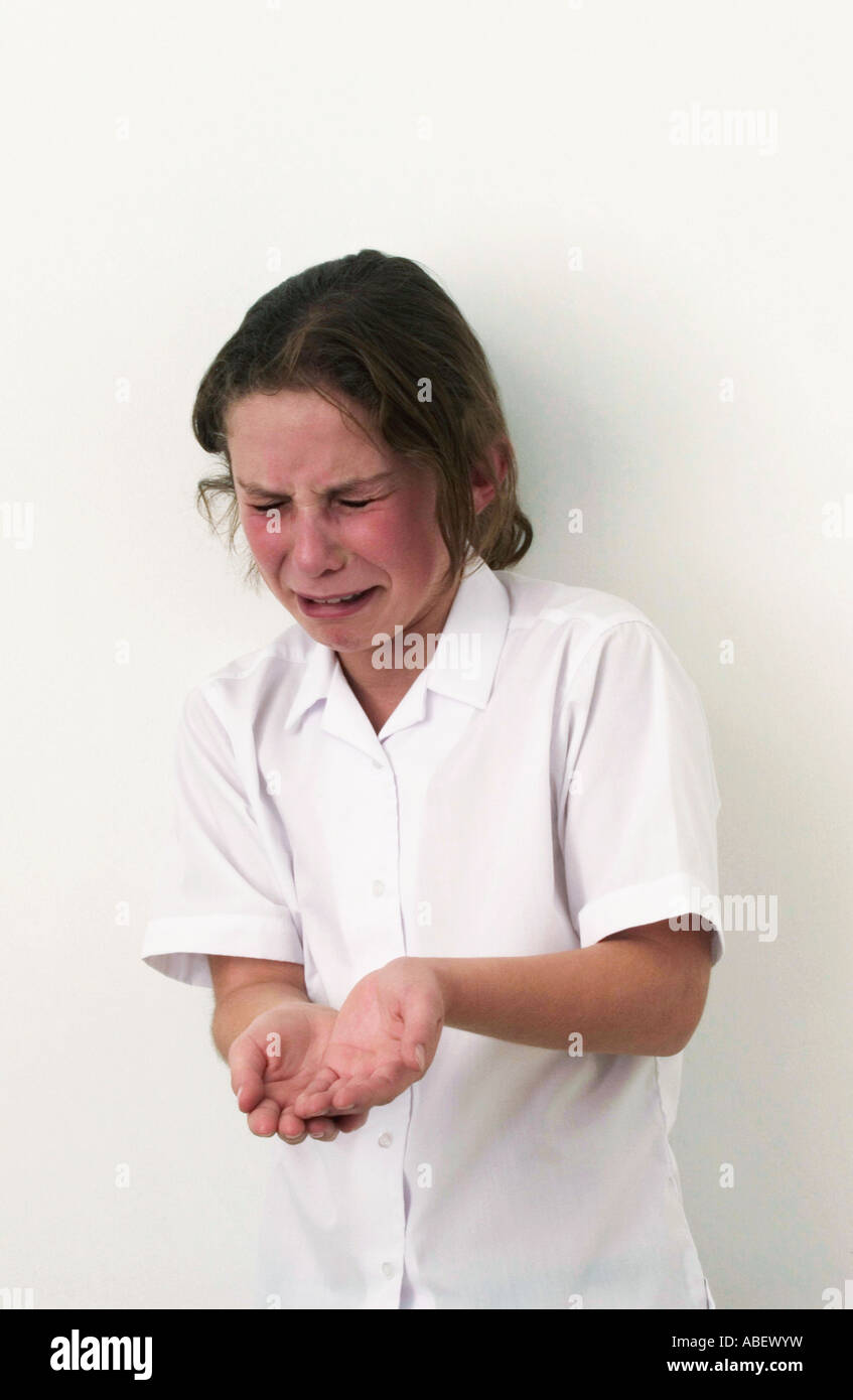 Girl holding out hand for smack and crying Stock Photo