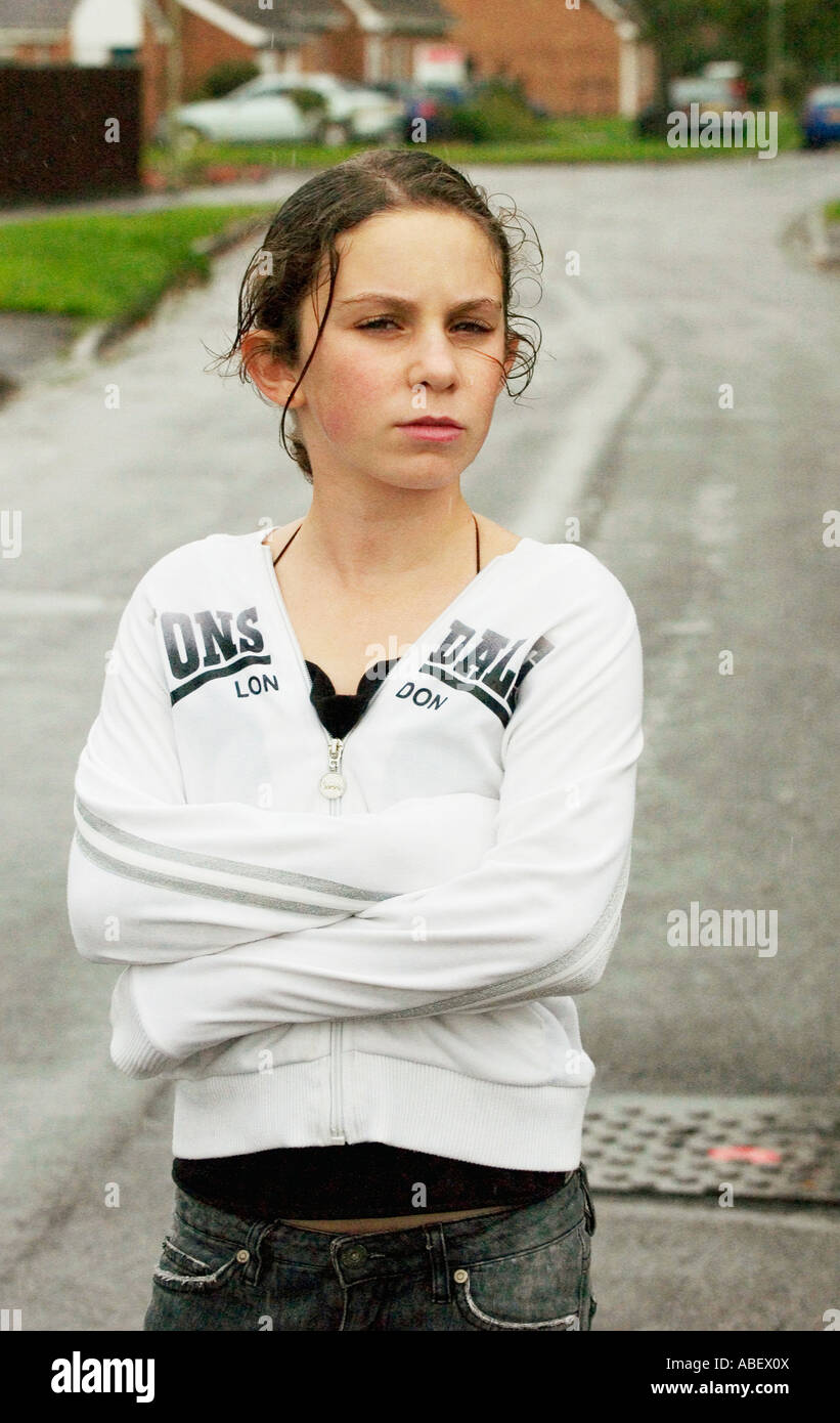 Portrait of girl standing in rain on residential street Stock Photo - Alamy