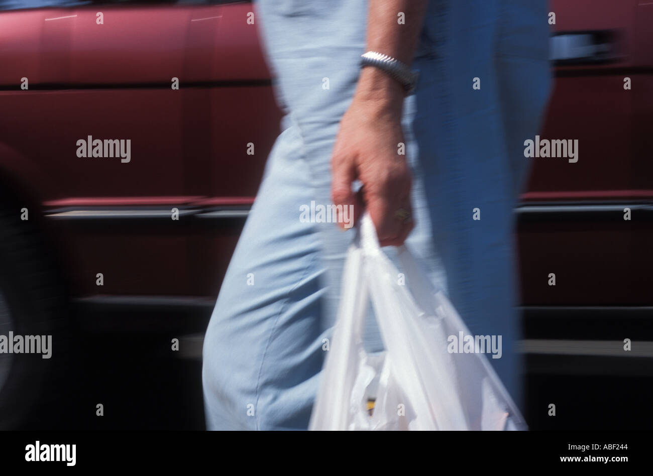 Shoppers carrying plastic shopping bags hires stock photography and
