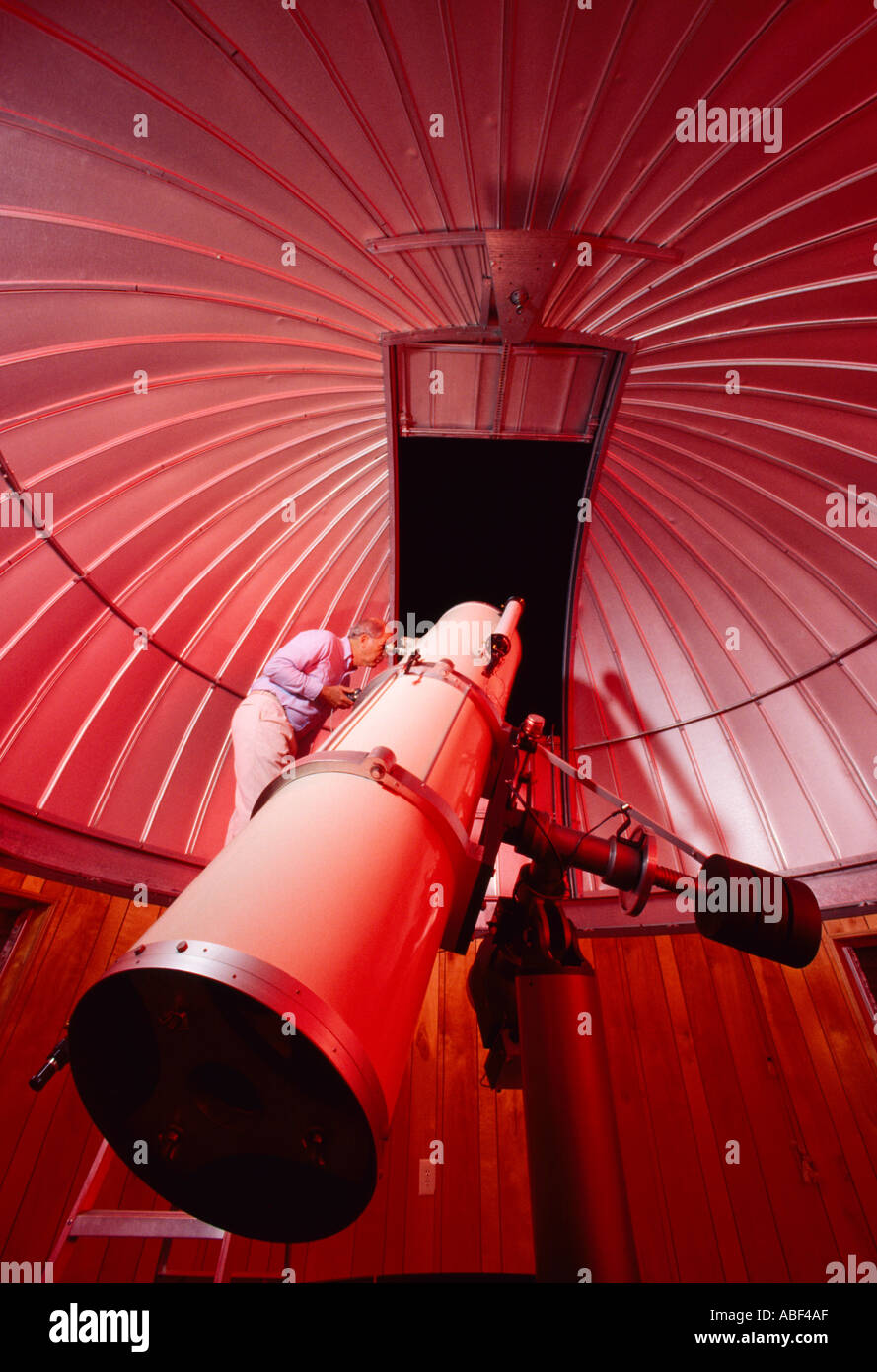 Astronomy - An amateur astronomer views the night sky through the 18' Newtonian reflecting type telescope that he built / USA. Stock Photo