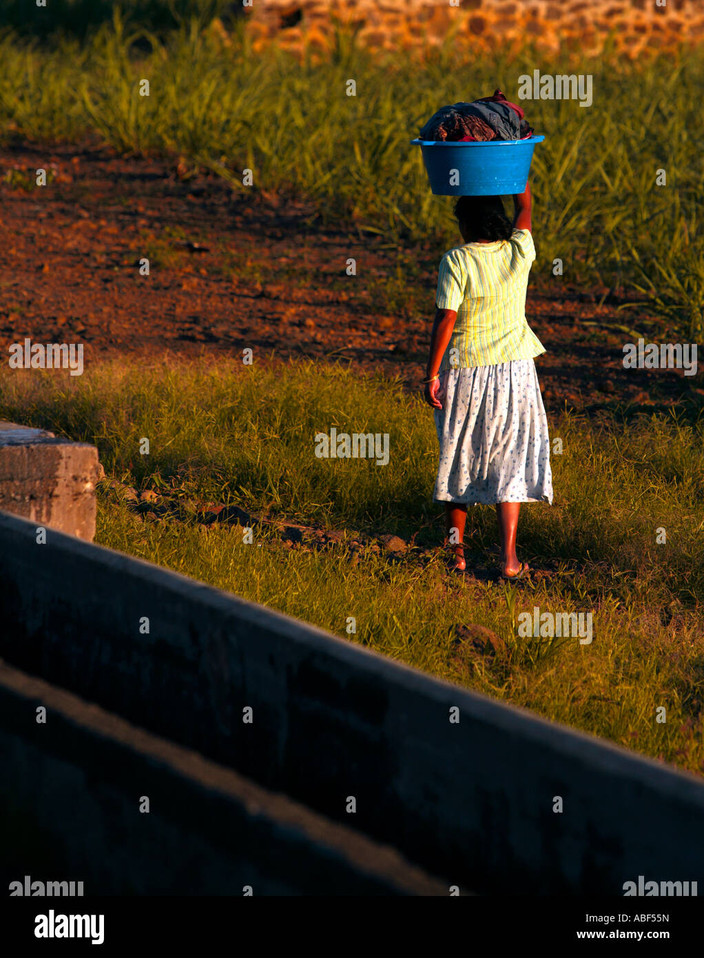 Lady returns home with the family's washing - Mauritius. Stock Photo