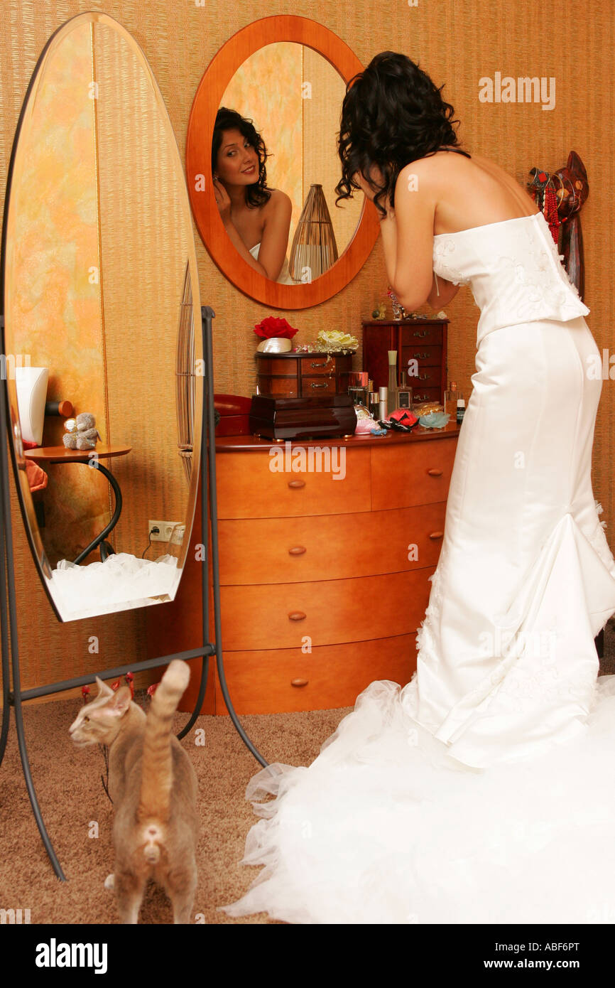 A bride applying make up on her wedding day. Stock Photo