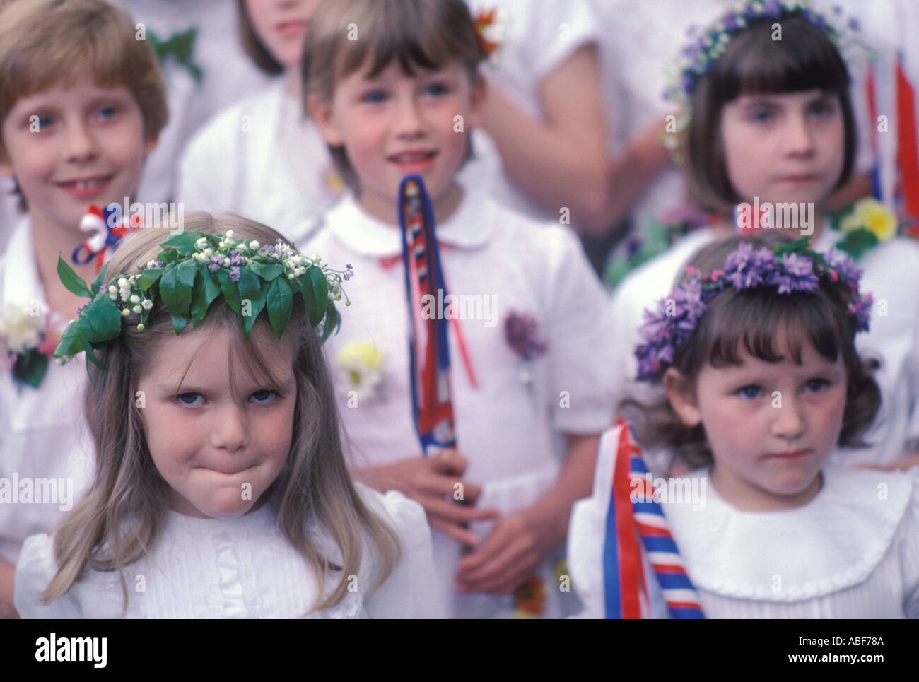 May flowers headdress school girls who follow the King and Queen through the village Castleton Garland Day May 29th 1980s Derbyshire UK Stock Photo