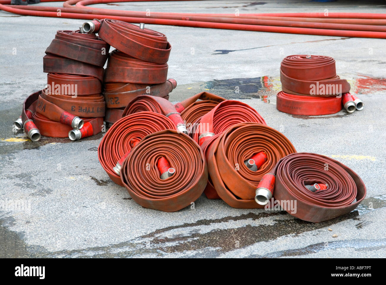 Fire hose lengths stacked up coiled and in use at a large fire in North West UK Stock Photo