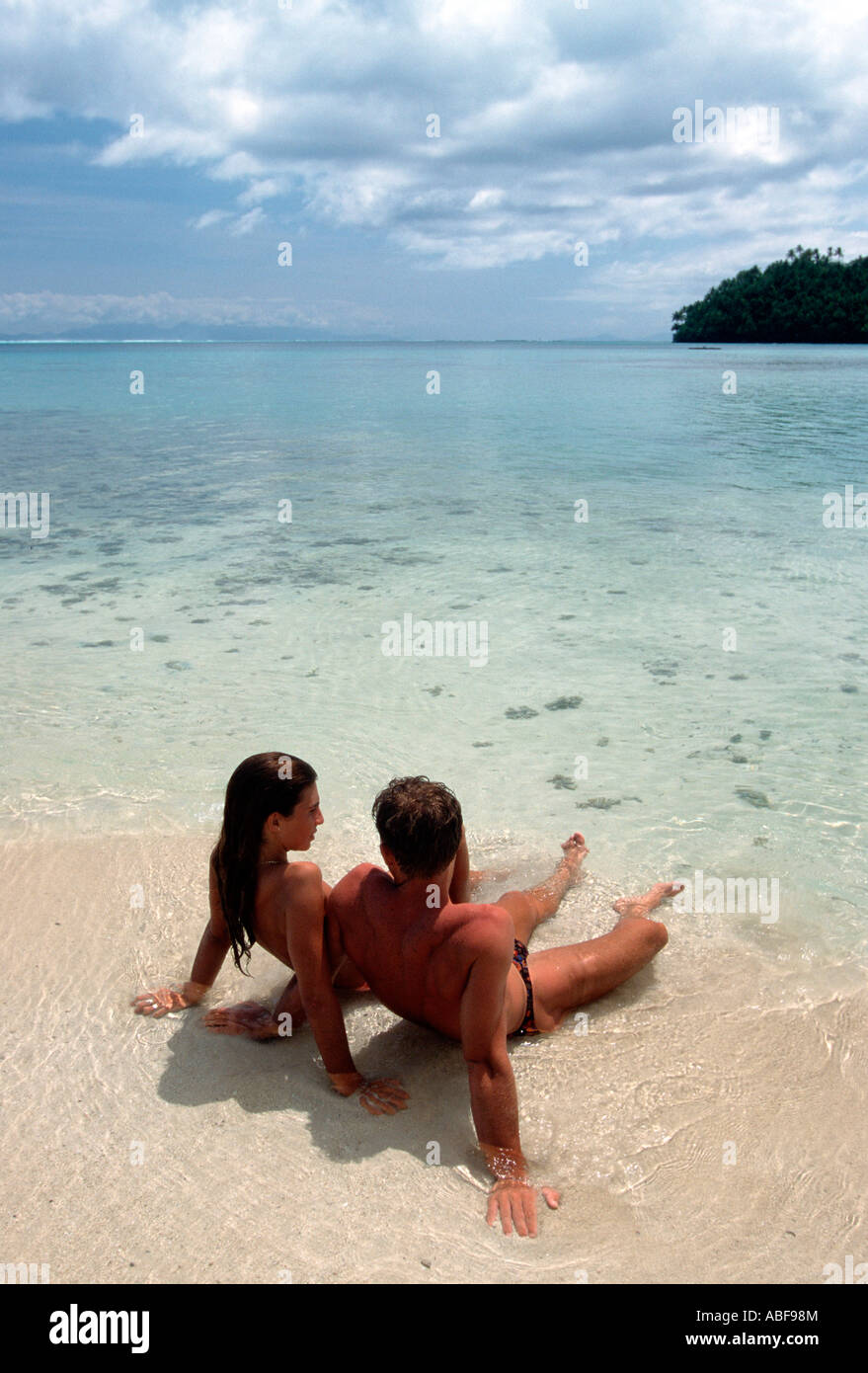 French Polynesia, couple sunbathing on the beach of Huahine island Stock Photo
